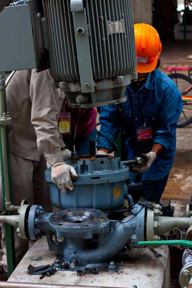 Workers Repairing Sundyne Pump